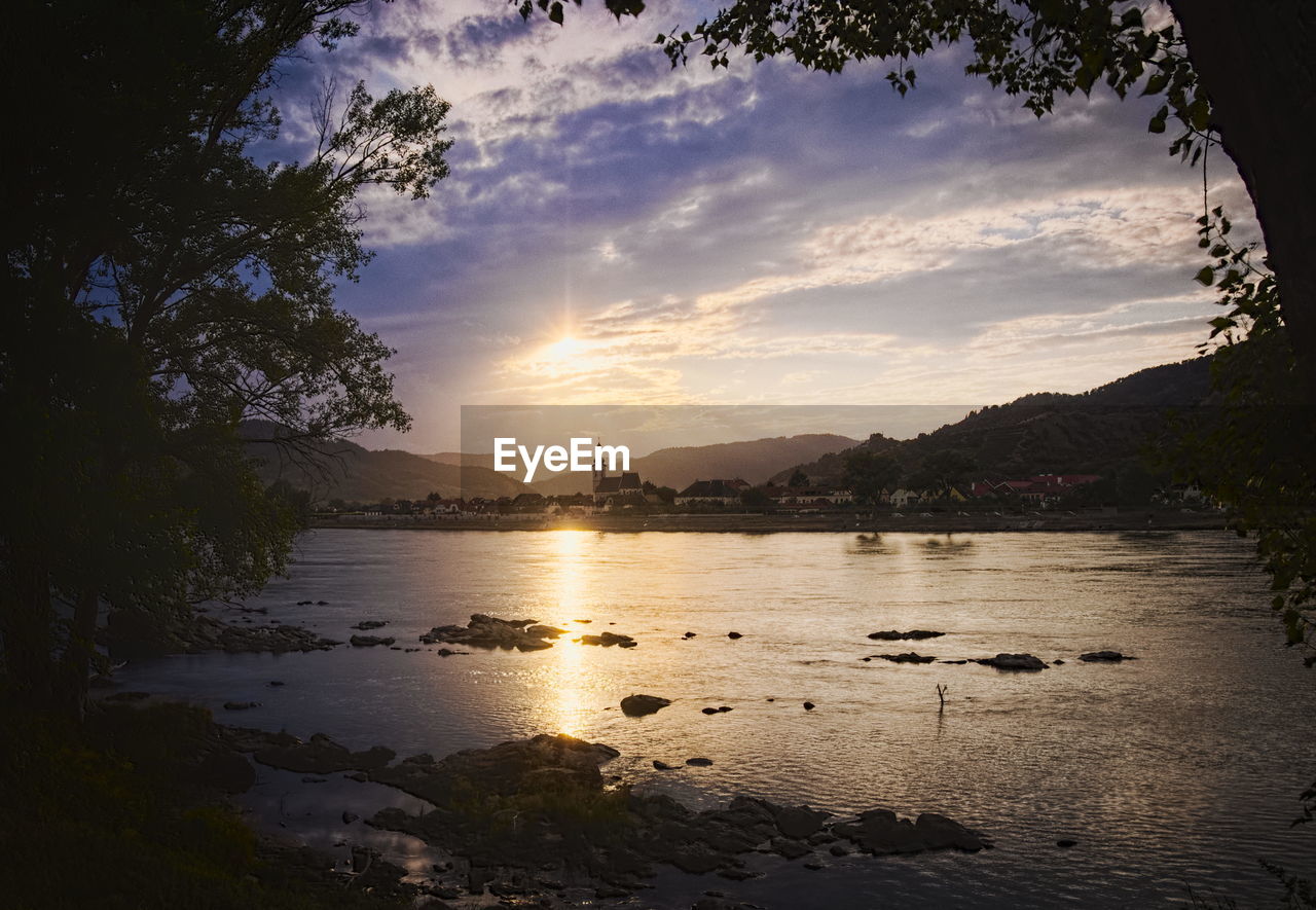 Scenic view of lake against sky during sunset