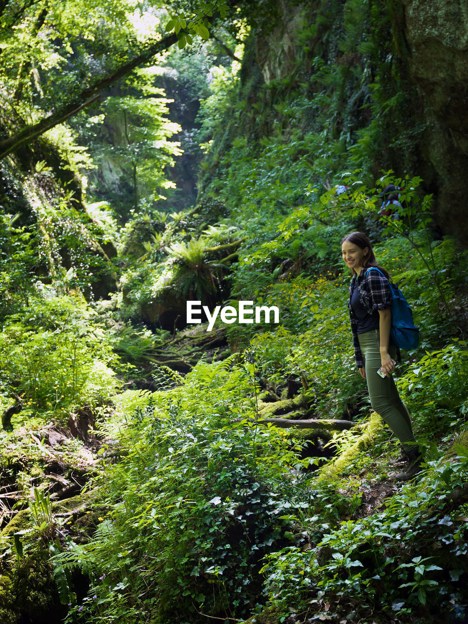 Side view of woman hiking in forest