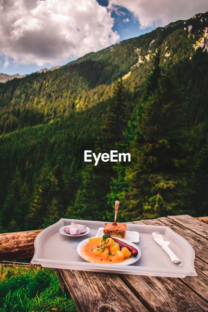 Food in plate on table against mountain
