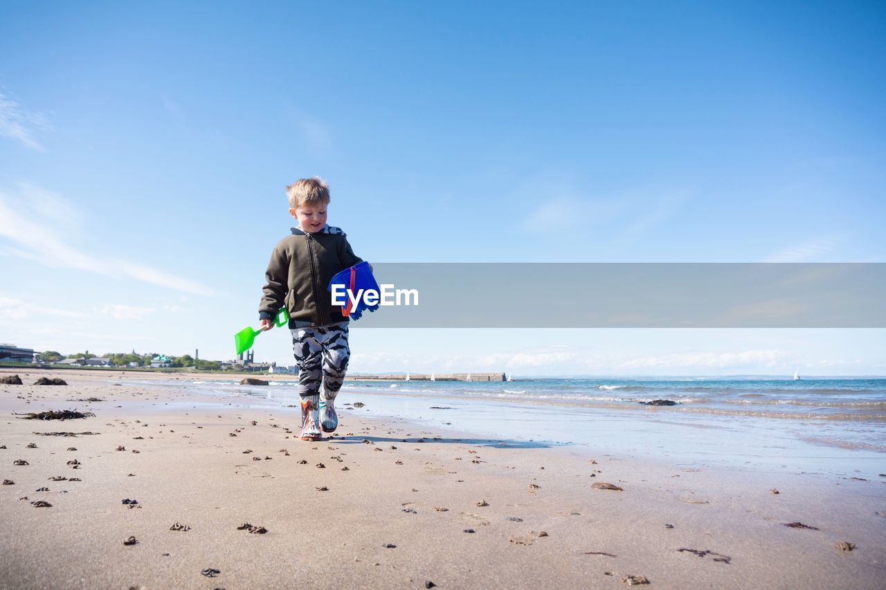 FULL LENGTH OF BOY ON BEACH