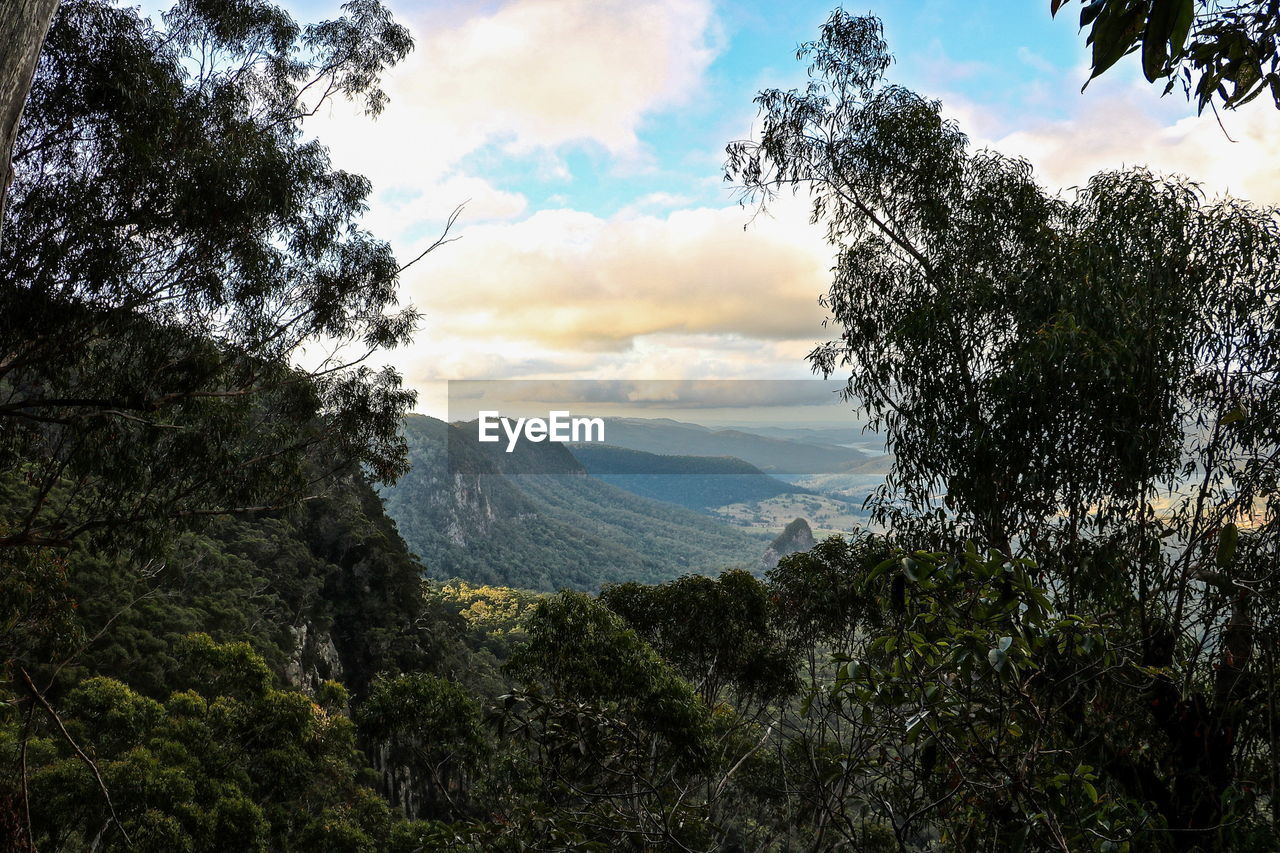 Scenic view of mountains against cloudy sky