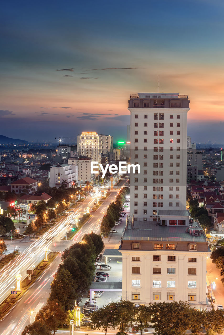 High angle view of illuminated buildings against sky during sunset