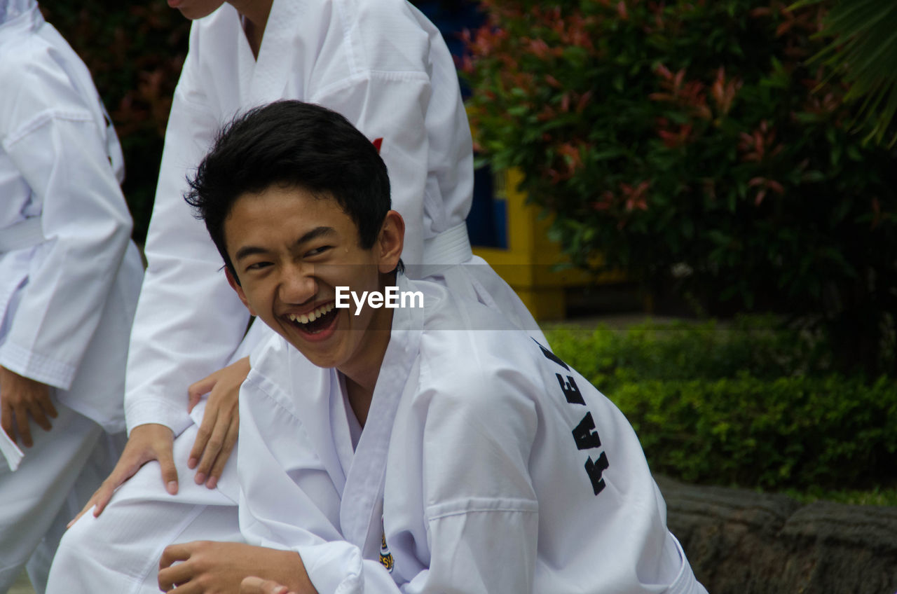 Portrait of teenage boy laughing outdoors