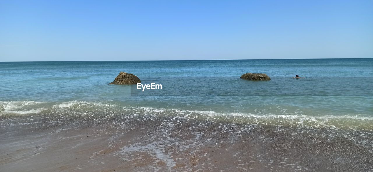 Scenic view of sea against clear blue sky