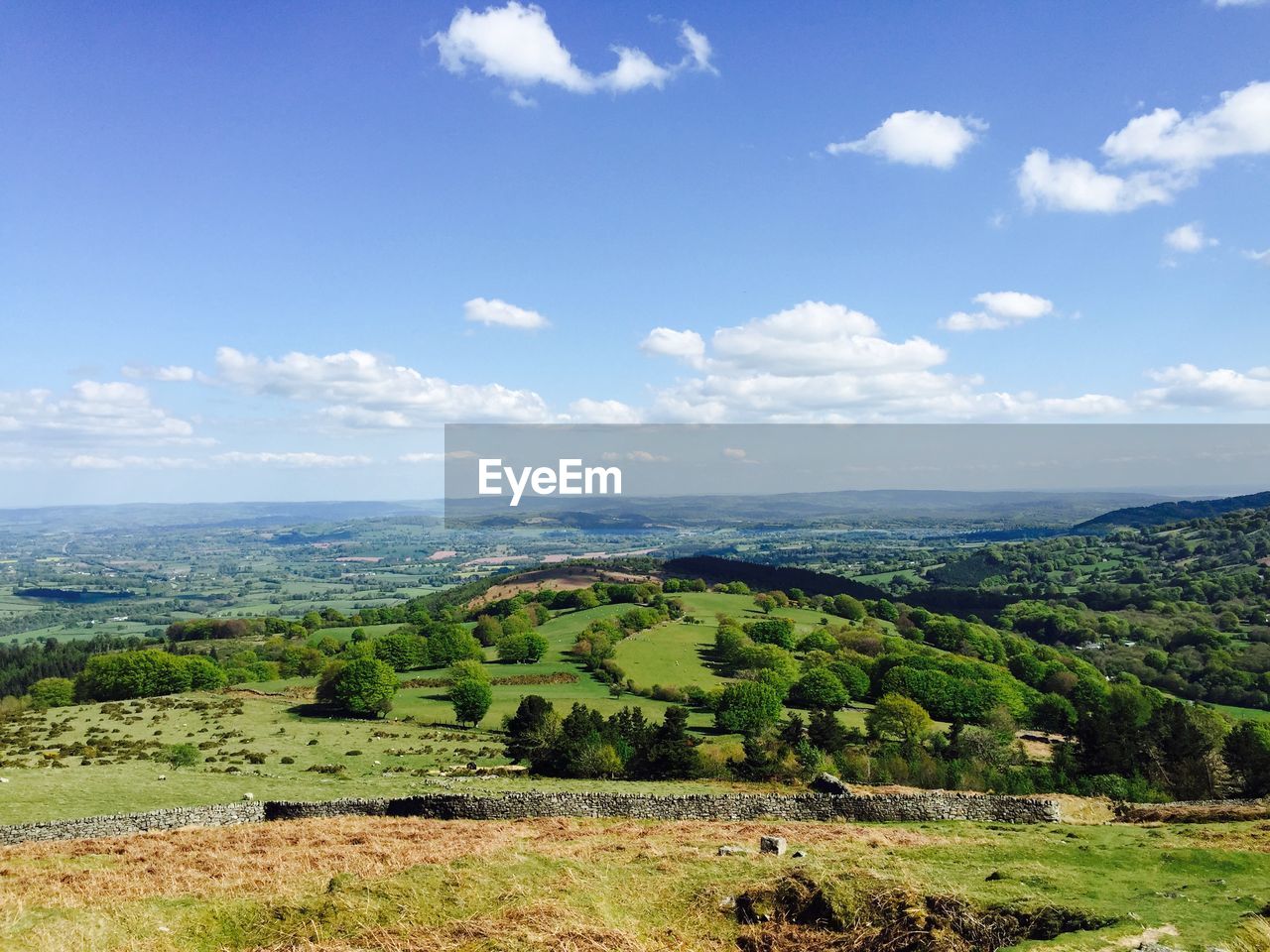 Scenic view of field against cloudy sky