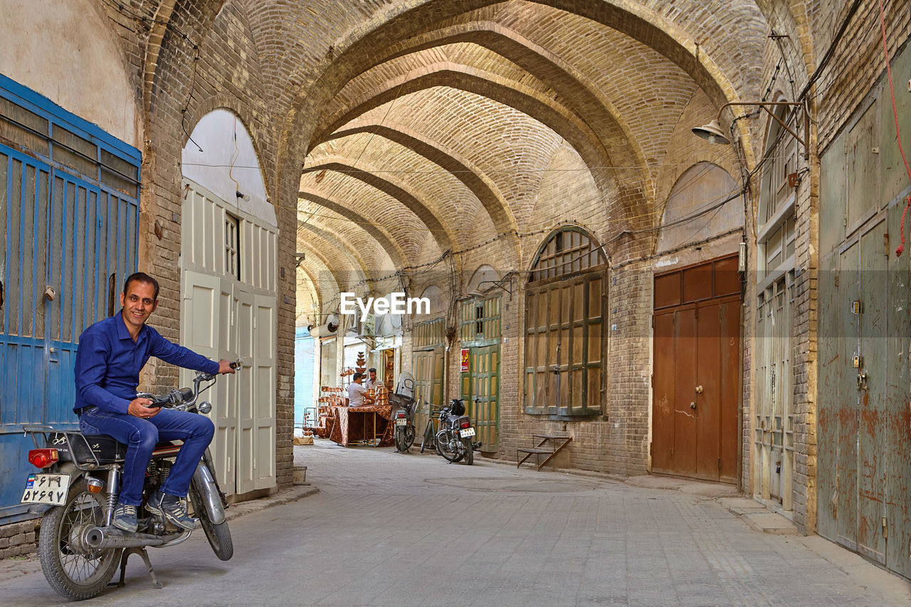 MAN SITTING IN BUILDING