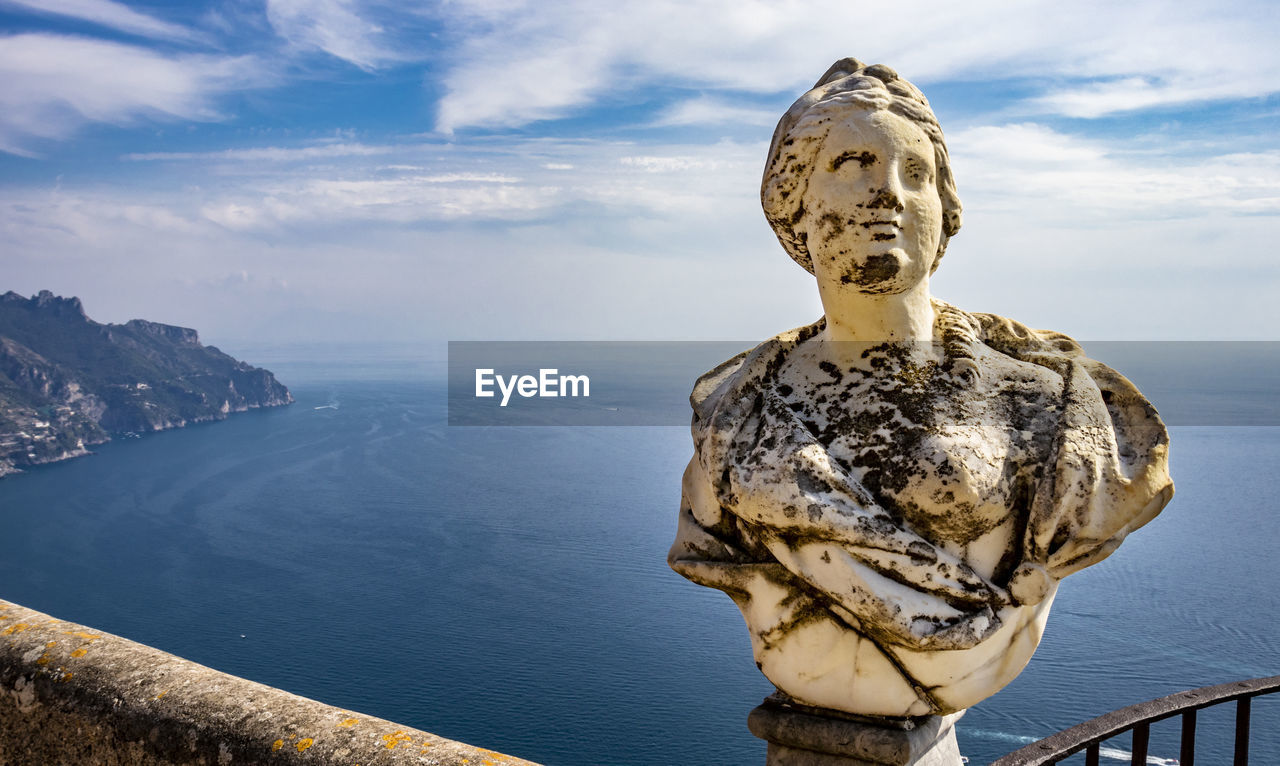 STATUE ON SEA AGAINST SKY