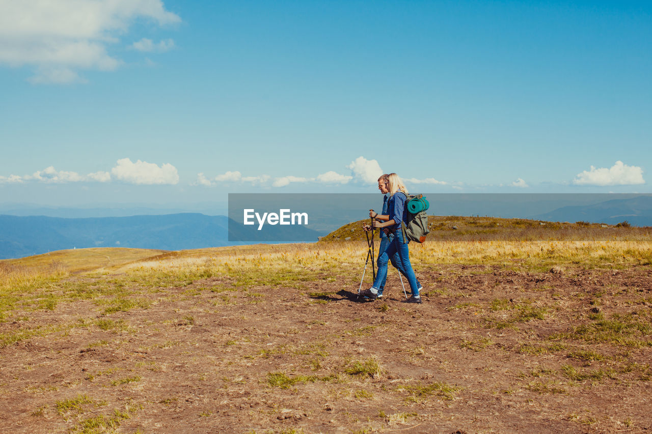 Man standing on field against sky