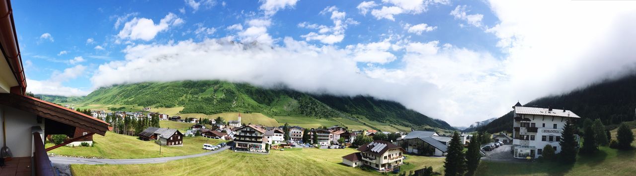 Panoramic view of houses on landscape against sky