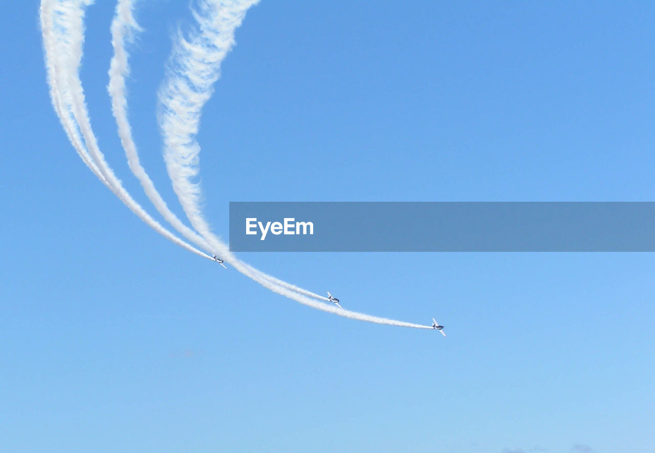 Low angle view of airplane flying against clear sky