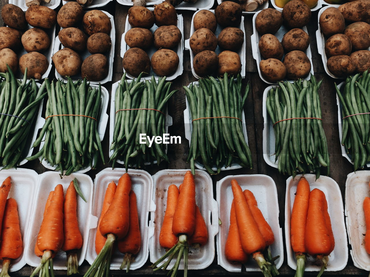 Full frame shot of carrots, potatoes, and green beans for sale