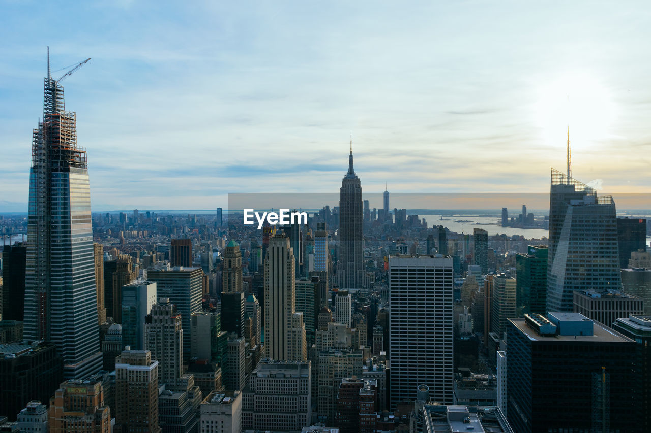 Aerial view of skyscrapers in new york city against cloudy sky