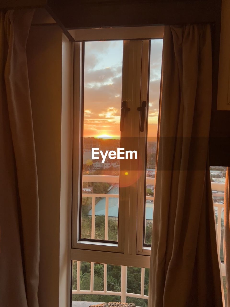 window, interior design, curtain, room, architecture, indoors, window covering, sky, sunset, nature, glass, home interior, built structure, building, window treatment, no people, home, house, wood, transparent, looking through window, residential district, day, city, sunlight, looking, travel, cloud, door