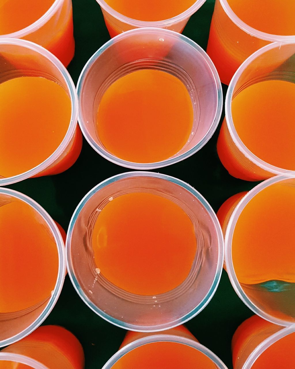 Full frame shot of fresh orange juice in disposable cups