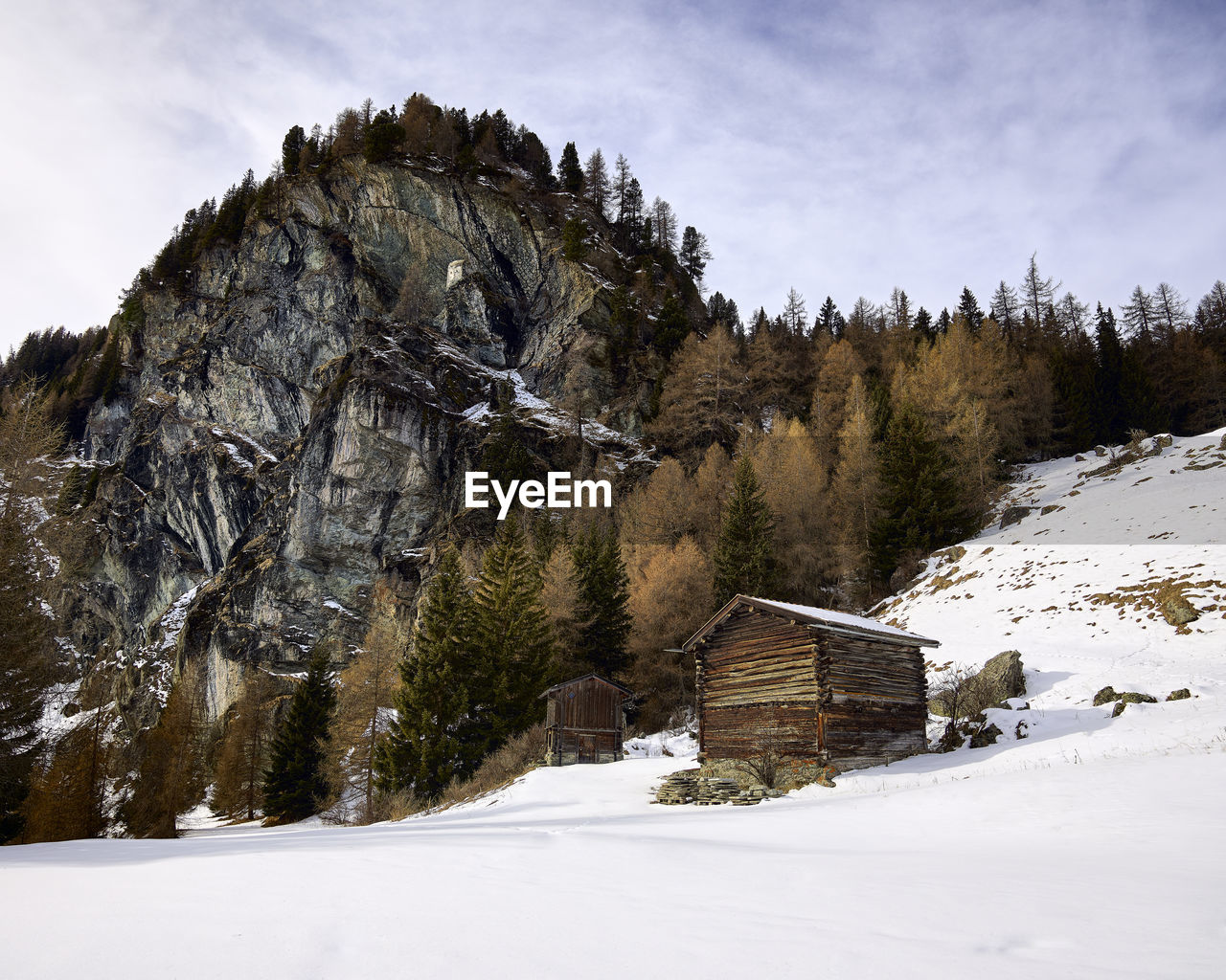 Wooden huts in wintery scene in swiss alps