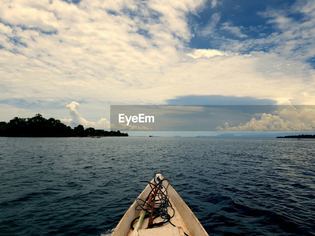 Boat sailing in sea against sky during sunset