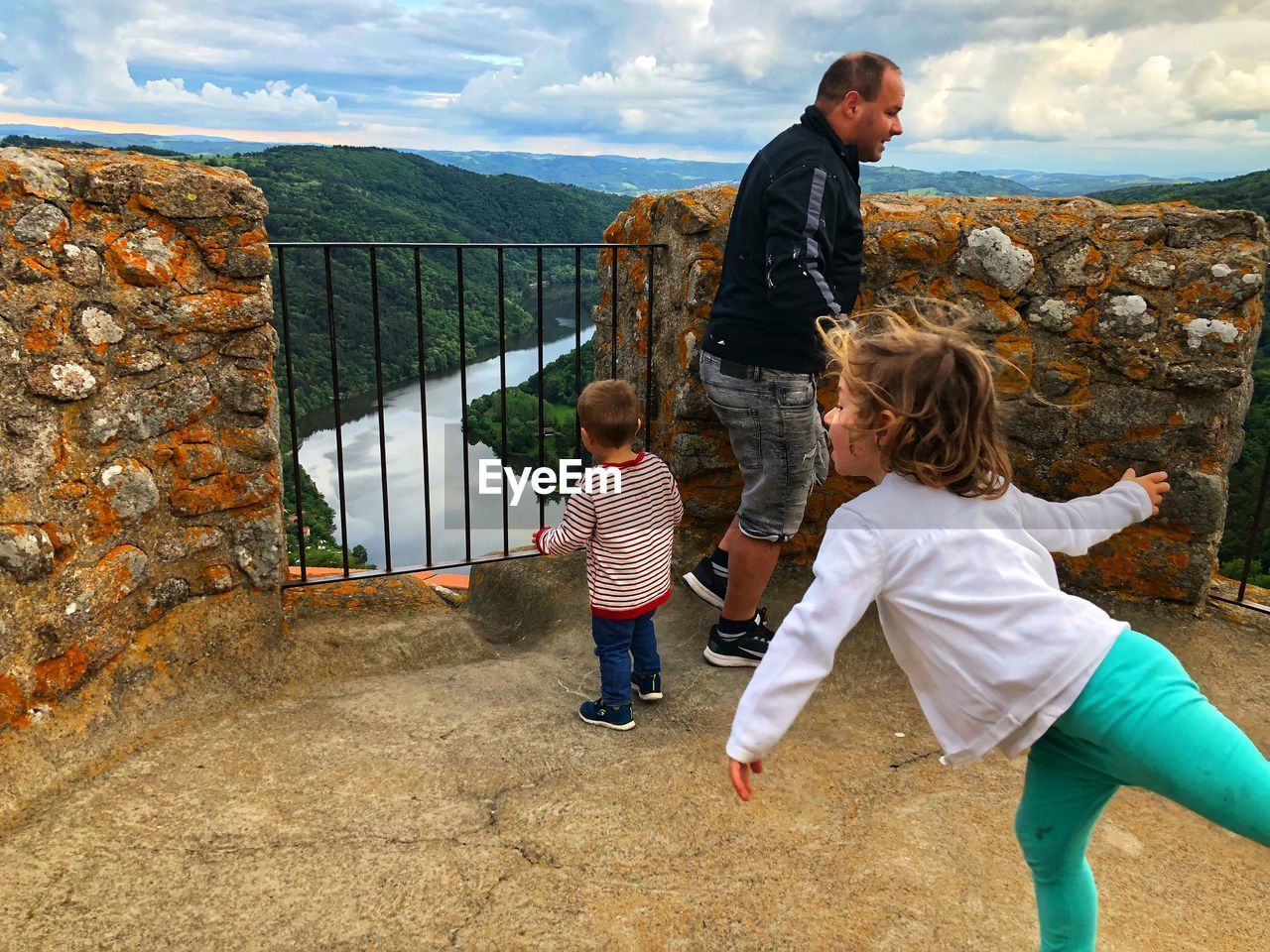 Family at observation point against mountains