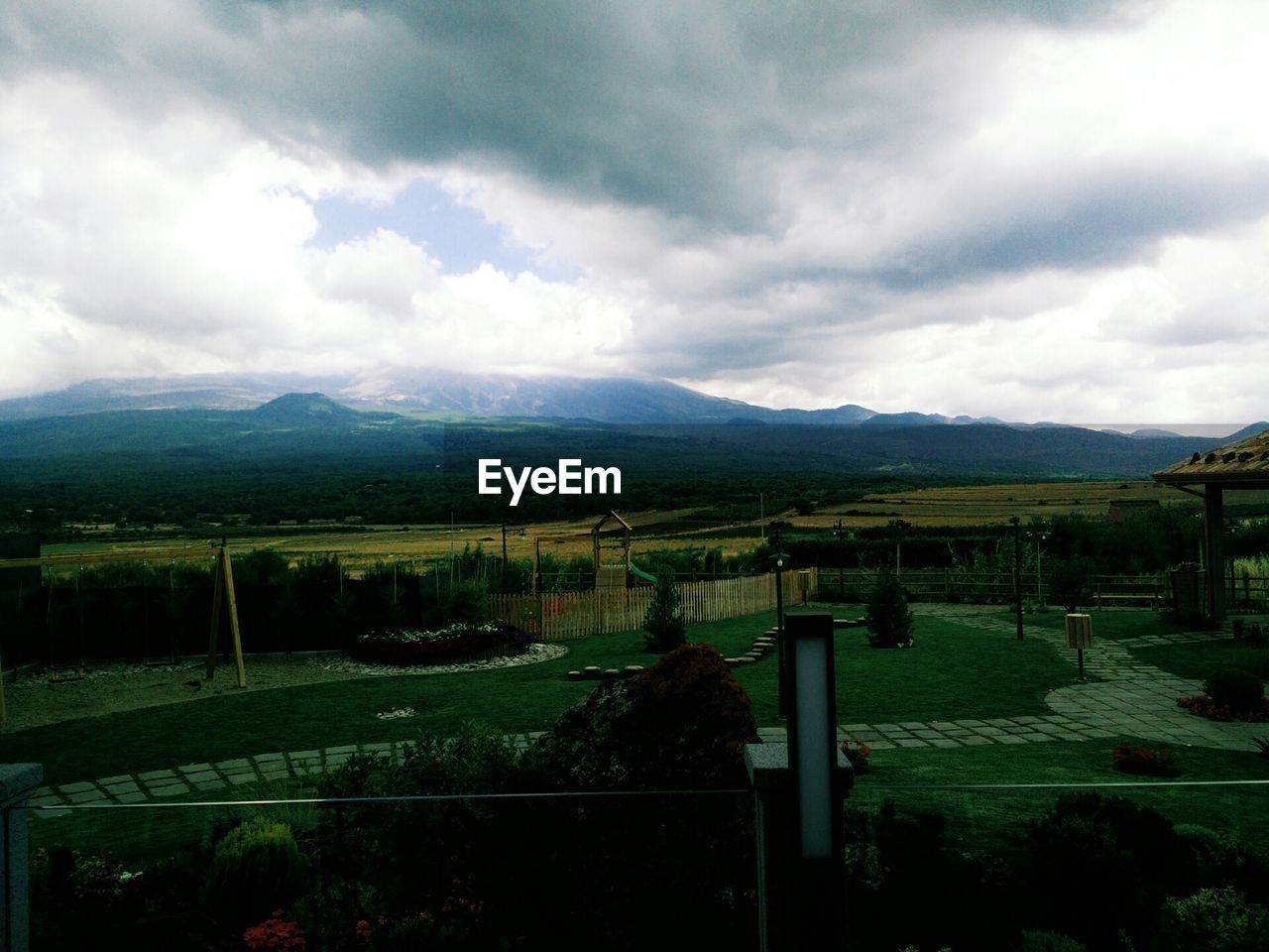 SCENIC VIEW OF MOUNTAINS AGAINST CLOUDY SKY