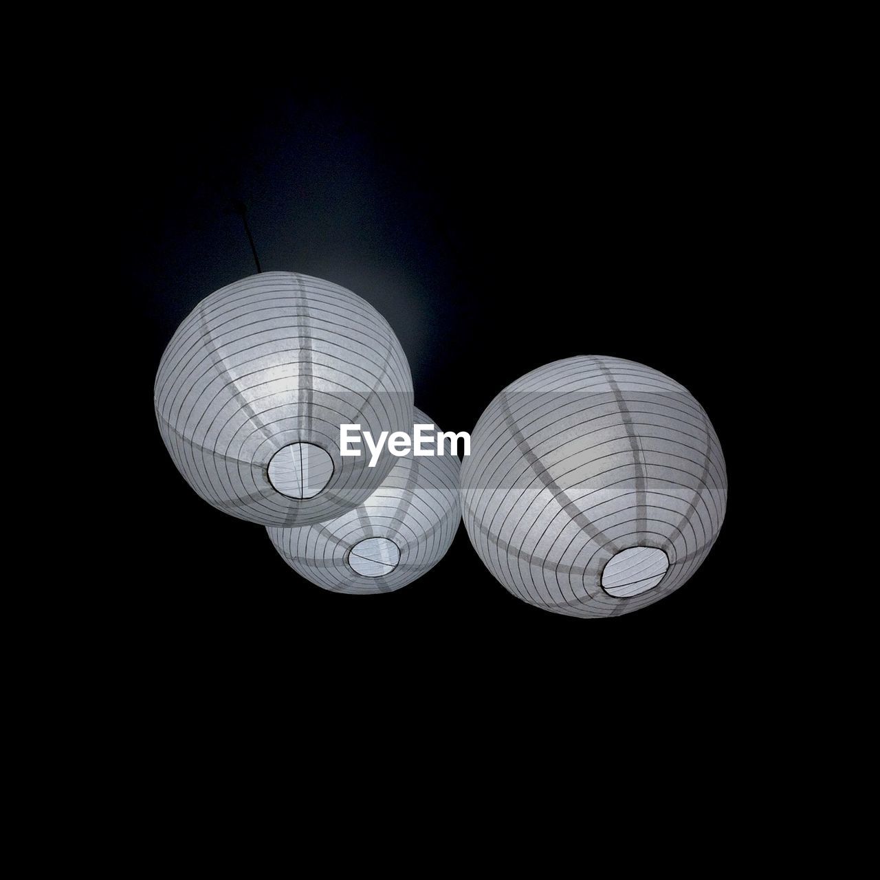 CLOSE-UP OF LANTERN OVER BLACK BACKGROUND