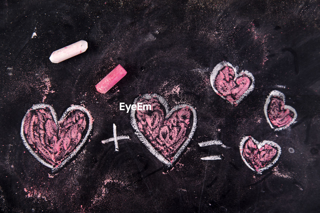 Close-up of heart shape chalk drawing on blackboard