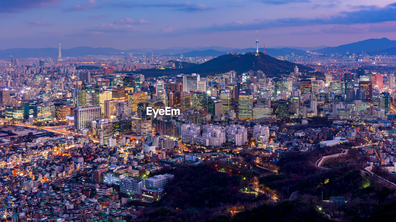 High angle view of illuminated cityscape against sky