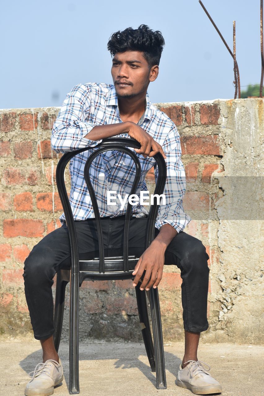 Young woman sitting on chair