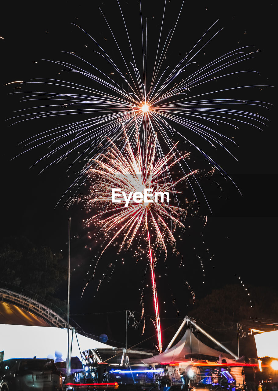 Low angle view of firework display at night