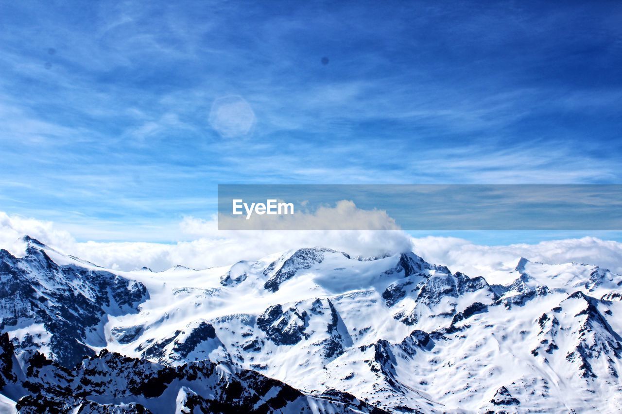 Scenic view of snowcapped mountains against sky