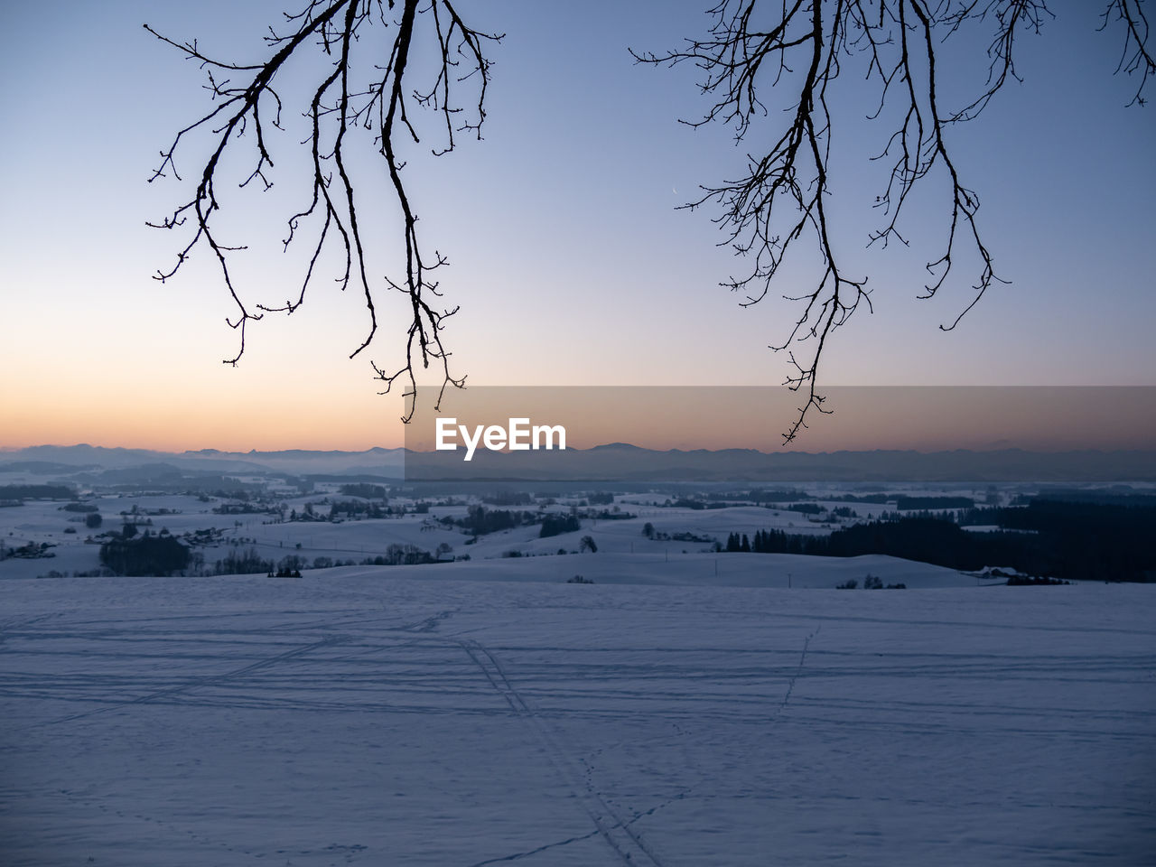 SNOW COVERED LAND DURING SUNSET