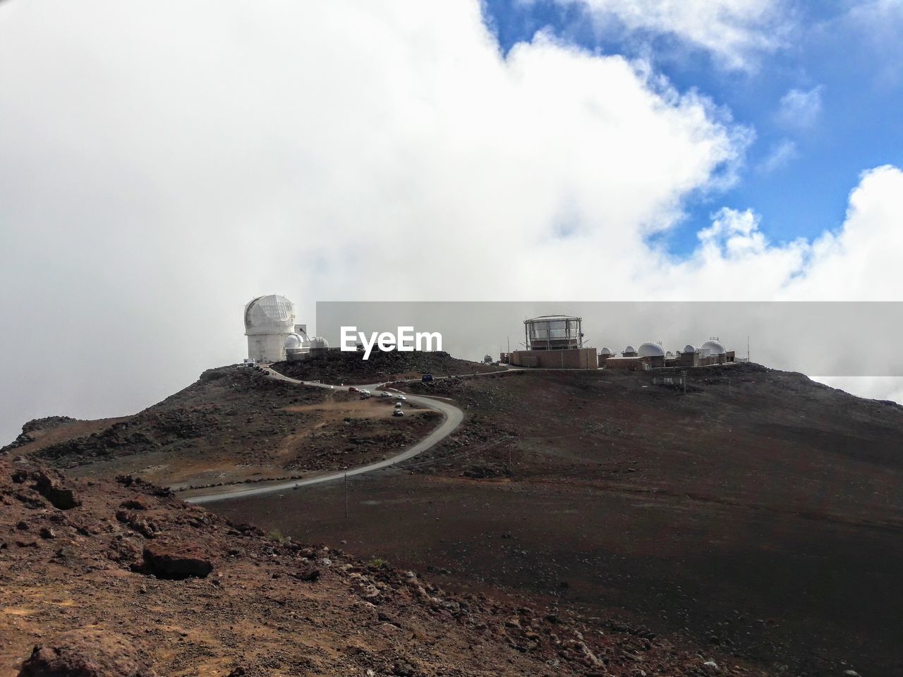 BUILT STRUCTURE ON LAND AGAINST MOUNTAIN