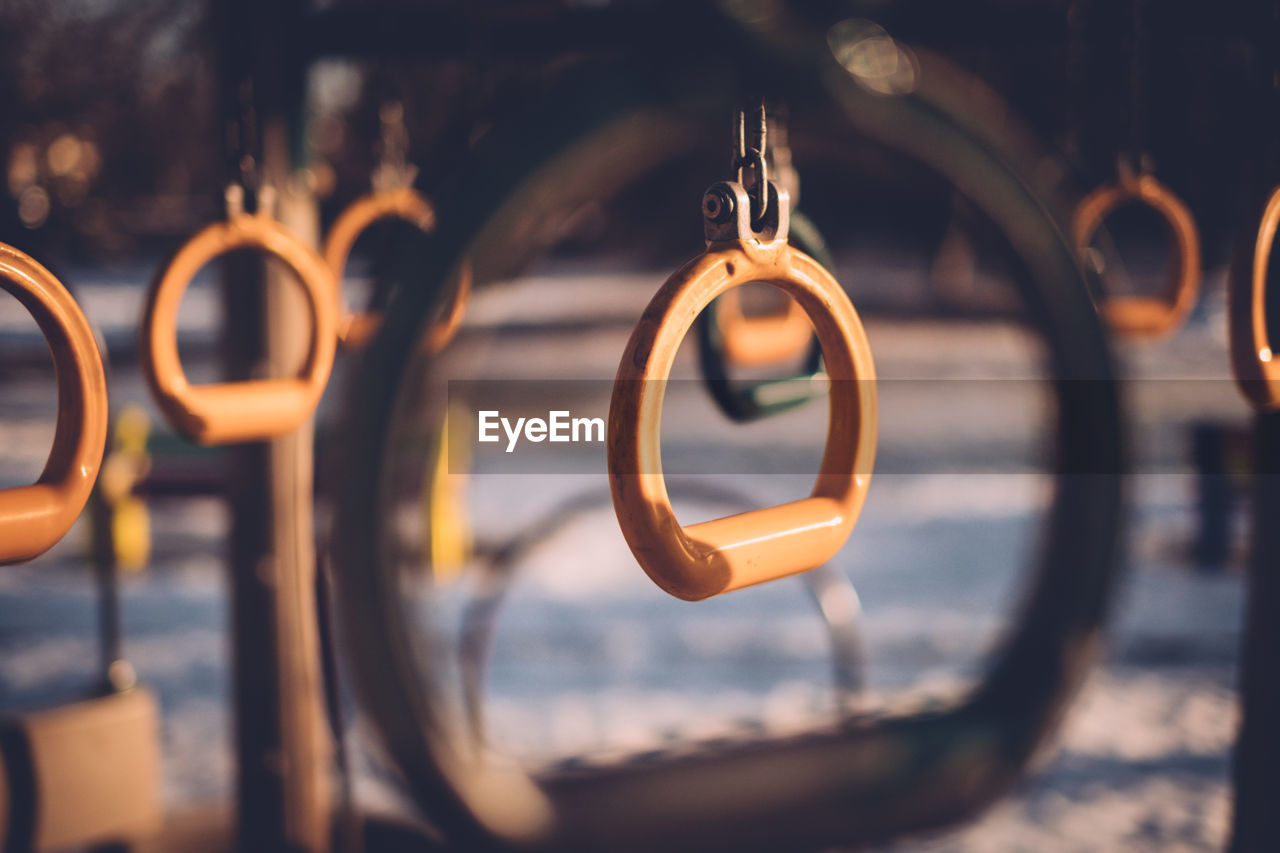 Metallic rings hanging in playground during winter