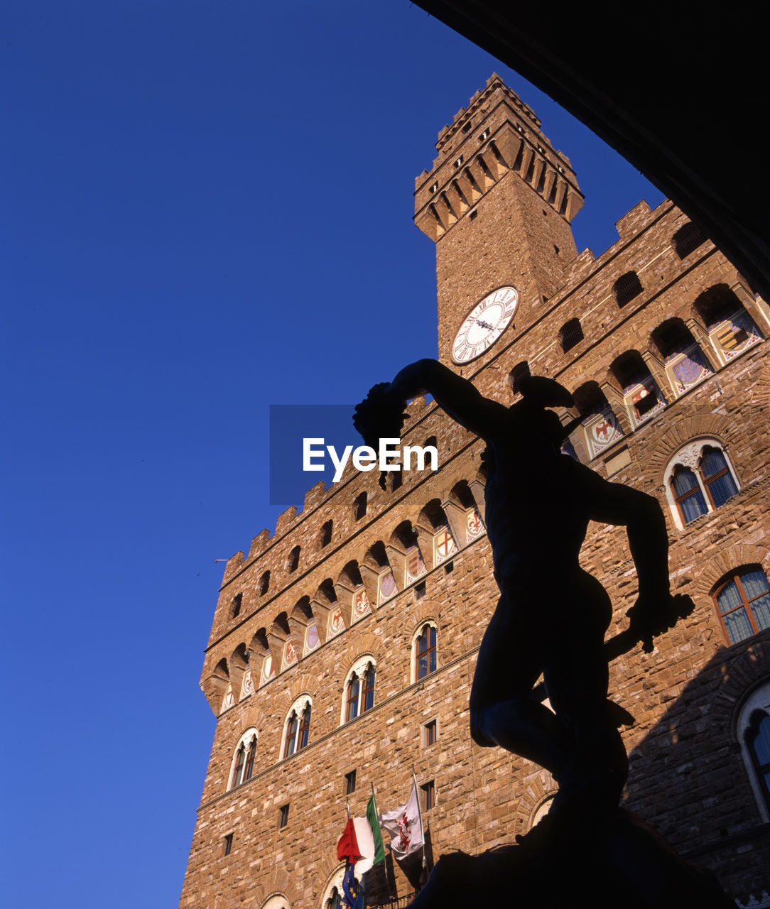 LOW ANGLE VIEW OF HISTORIC BUILDING AGAINST BLUE SKY