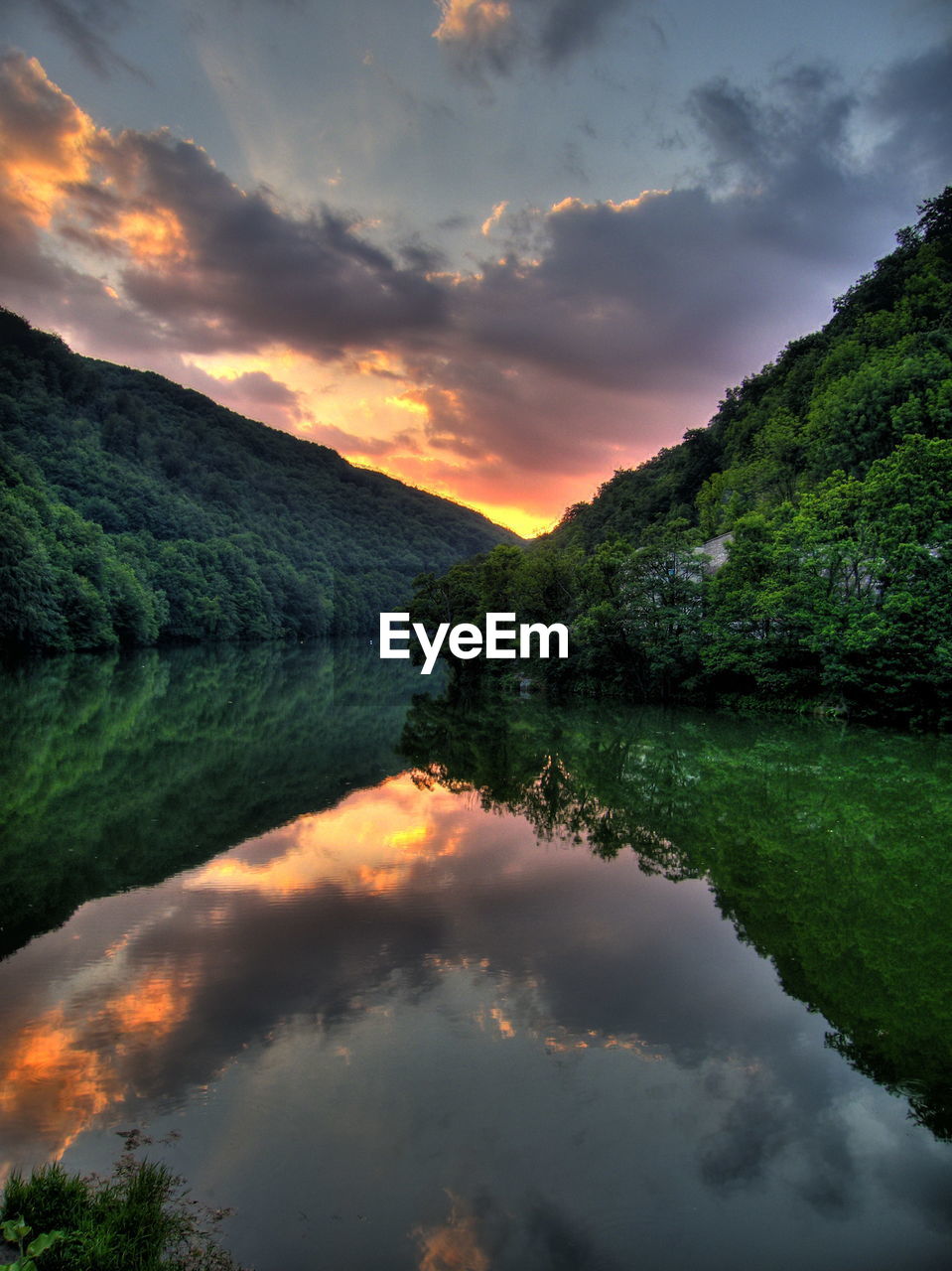 Scenic view of lake against sky during sunset