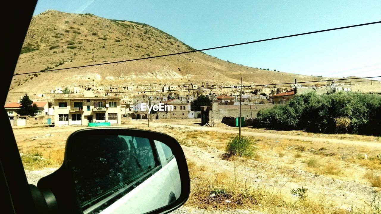 CAR ON ROAD AGAINST CLEAR SKY