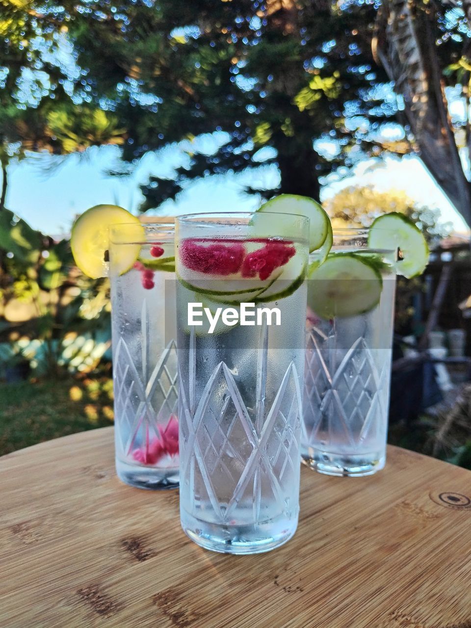 food and drink, table, glass, fruit, food, drinking glass, plant, no people, tree, household equipment, refreshment, nature, freshness, drink, healthy eating, wood, focus on foreground, outdoors, day, citrus fruit, lighting, container, lemon, summer, jar, wellbeing