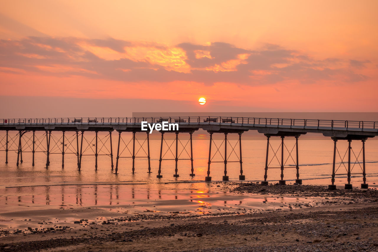 Scenic view of sea against orange sky