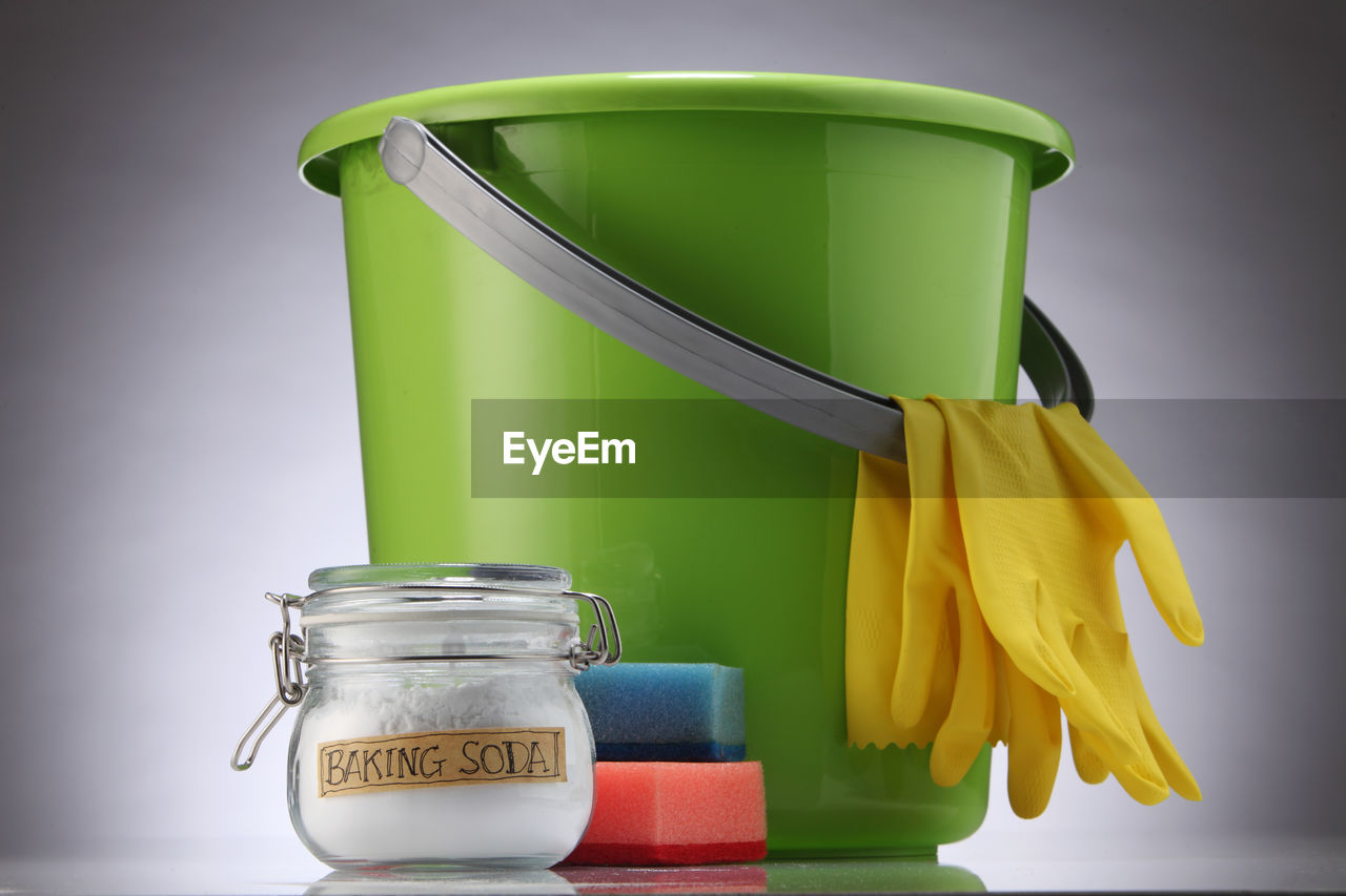 CLOSE-UP OF YELLOW JAR ON TABLE