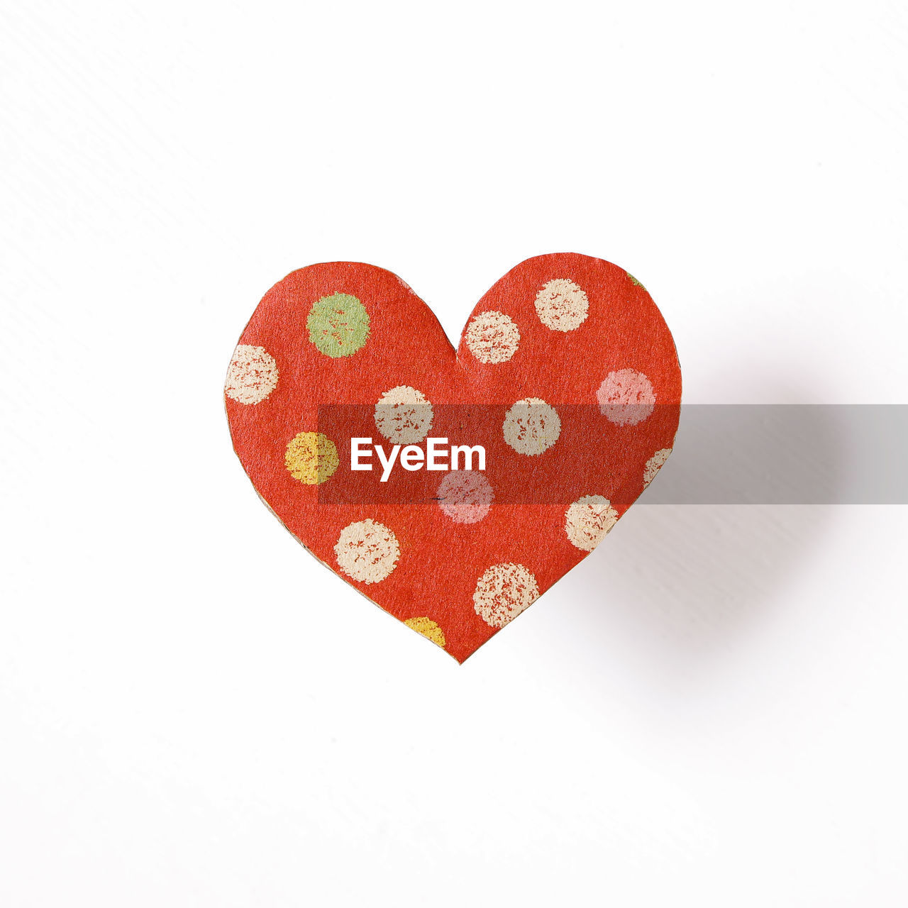 Close-up of heart shape decor over white background