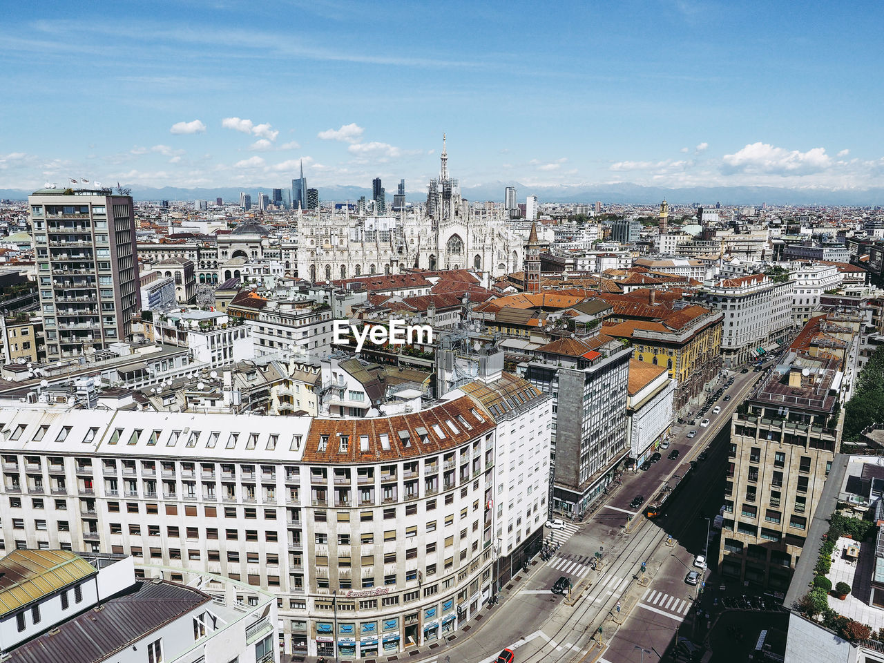 Aerial view of cityscape against sky during sunny day