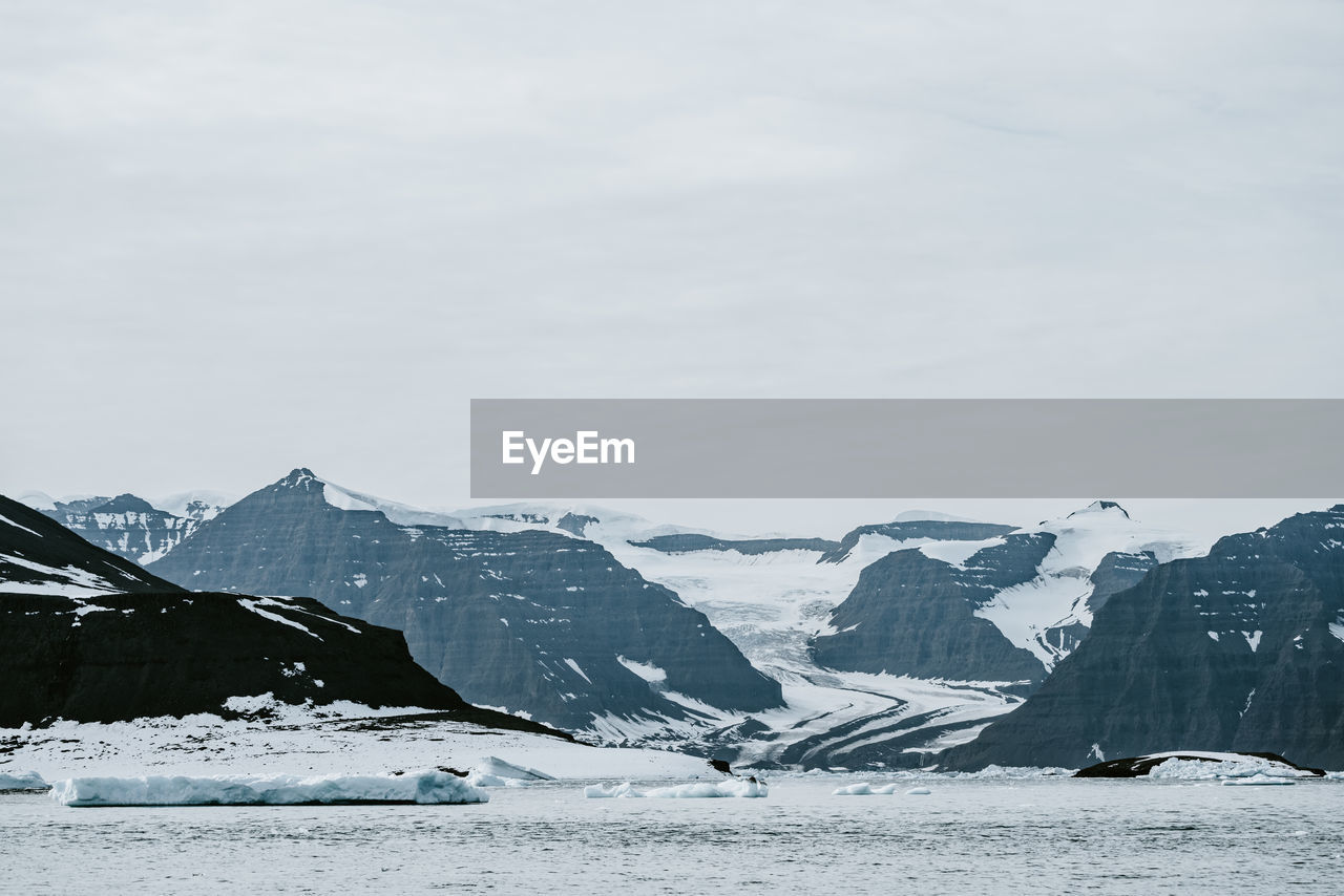 scenic view of snowcapped mountains against sky during winter