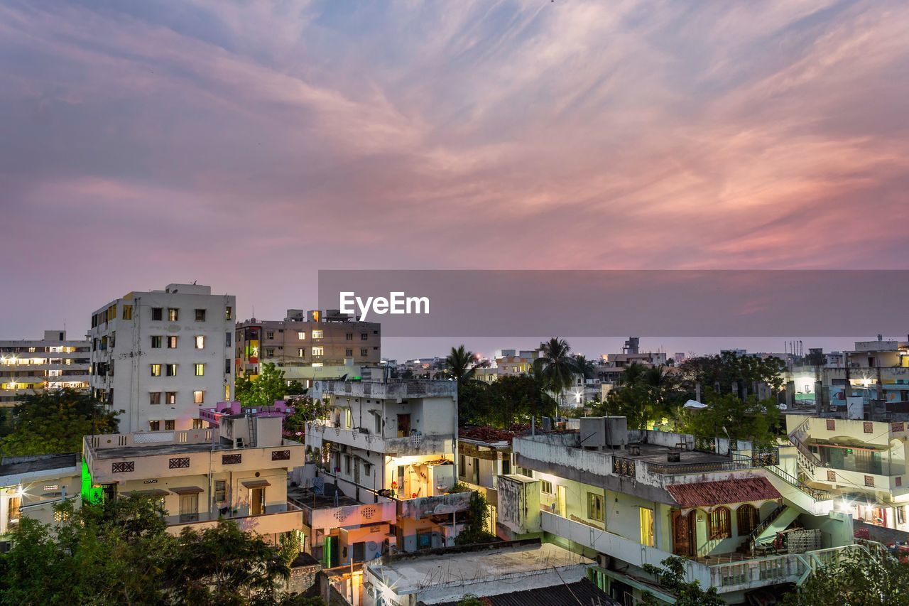 High angle view of buildings against sky at sunset