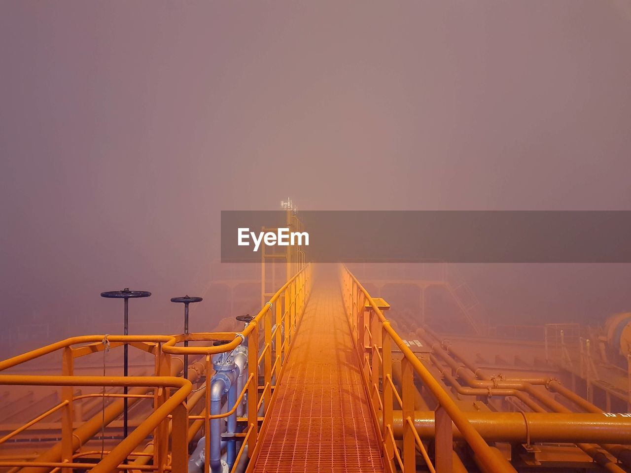 Metallic bridge in foggy weather 