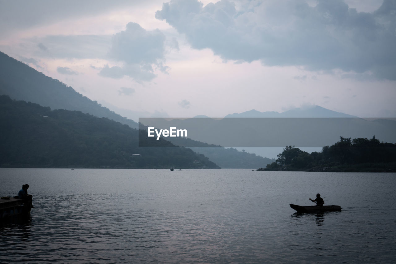 View of kayak and volcano in the distance seen from the lake atitlan surface in guatemala