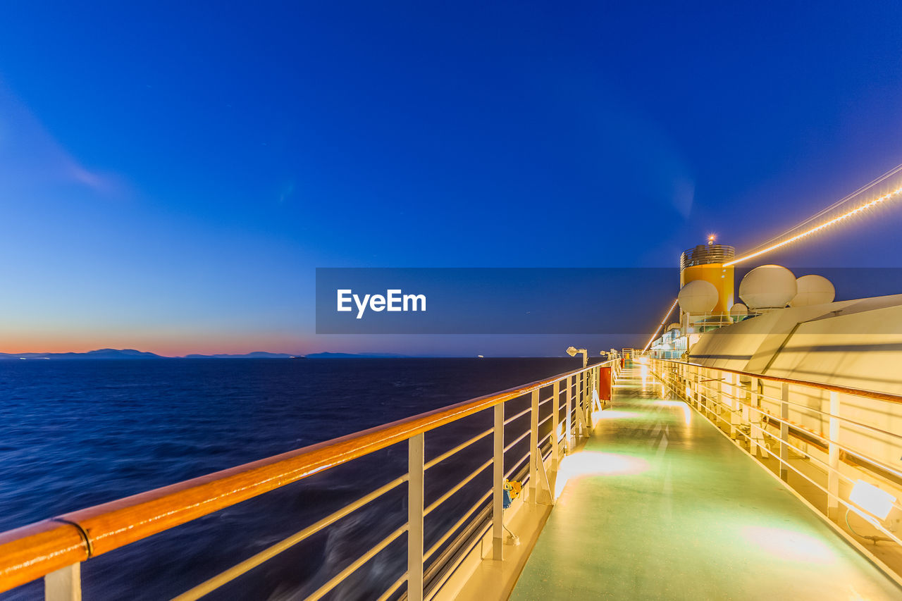 Scenic view of sea against blue sky at night from cruise ship deck 