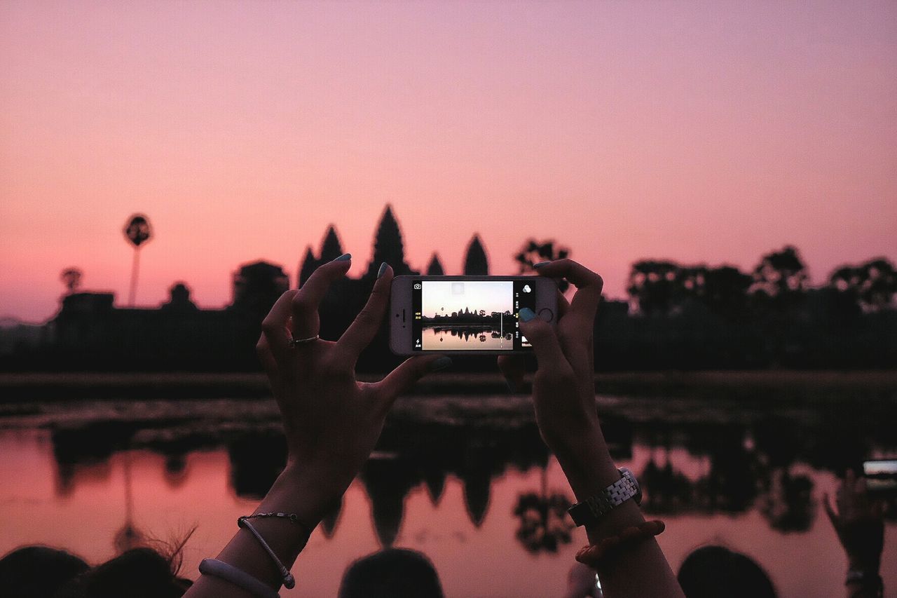 PERSON PHOTOGRAPHING THROUGH SMART PHONE