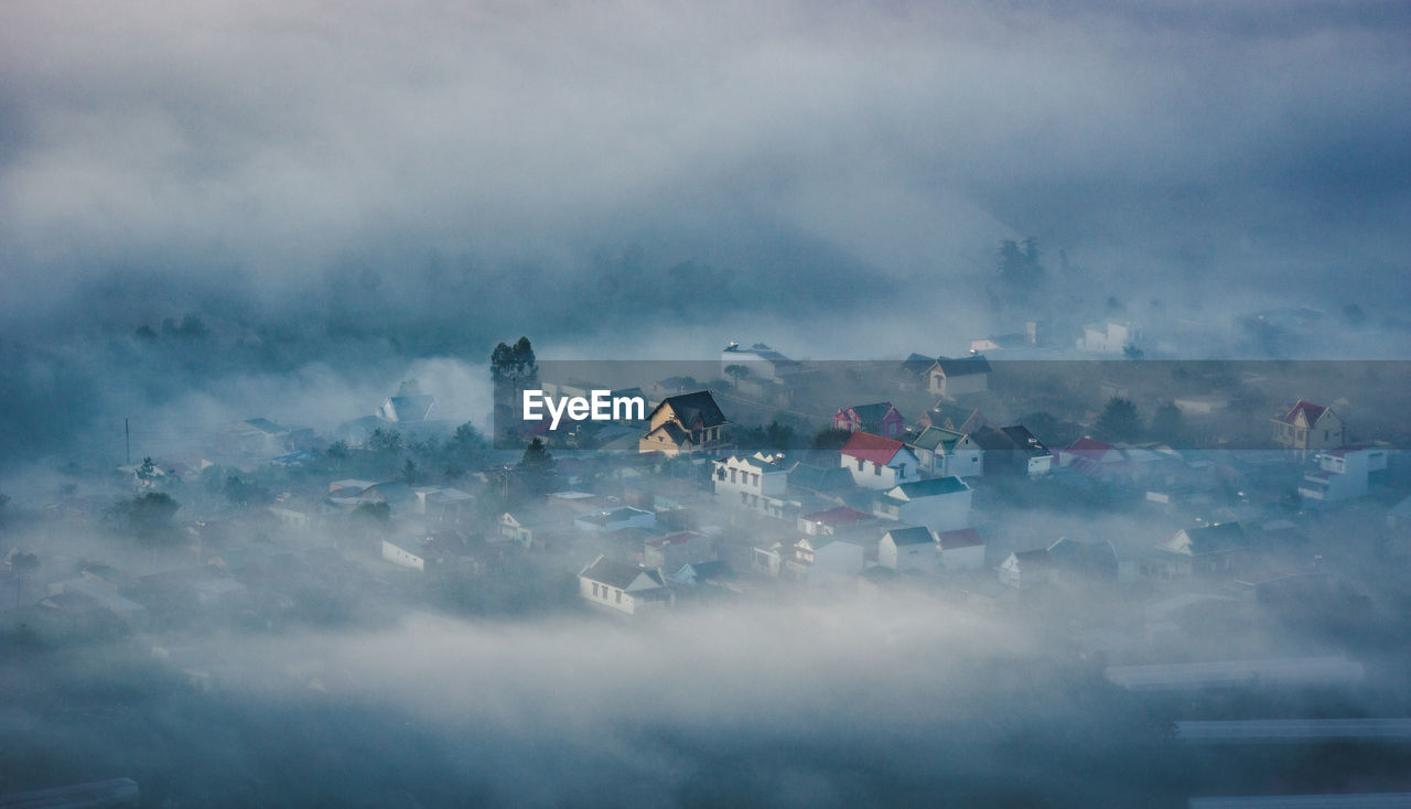 Aerial view of townscape during foggy weather