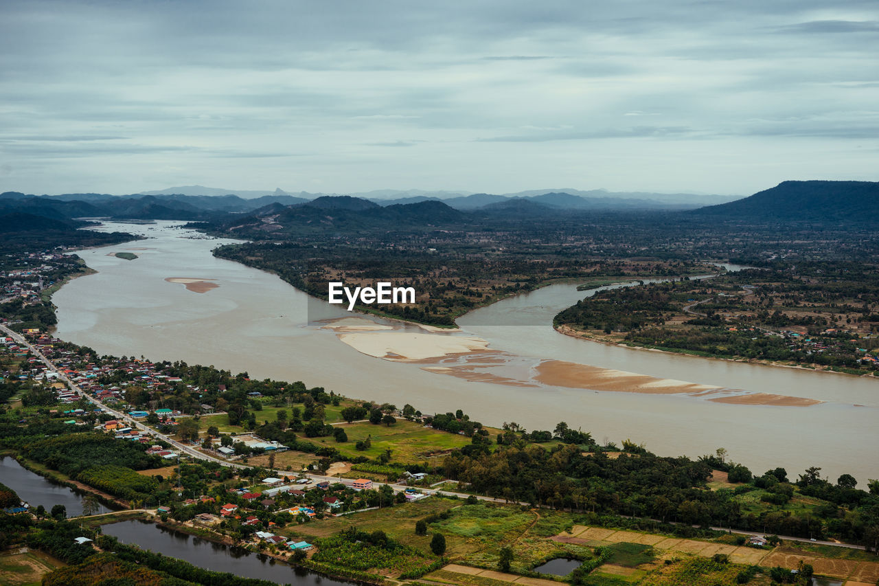 High angle view of townscape by river against sky