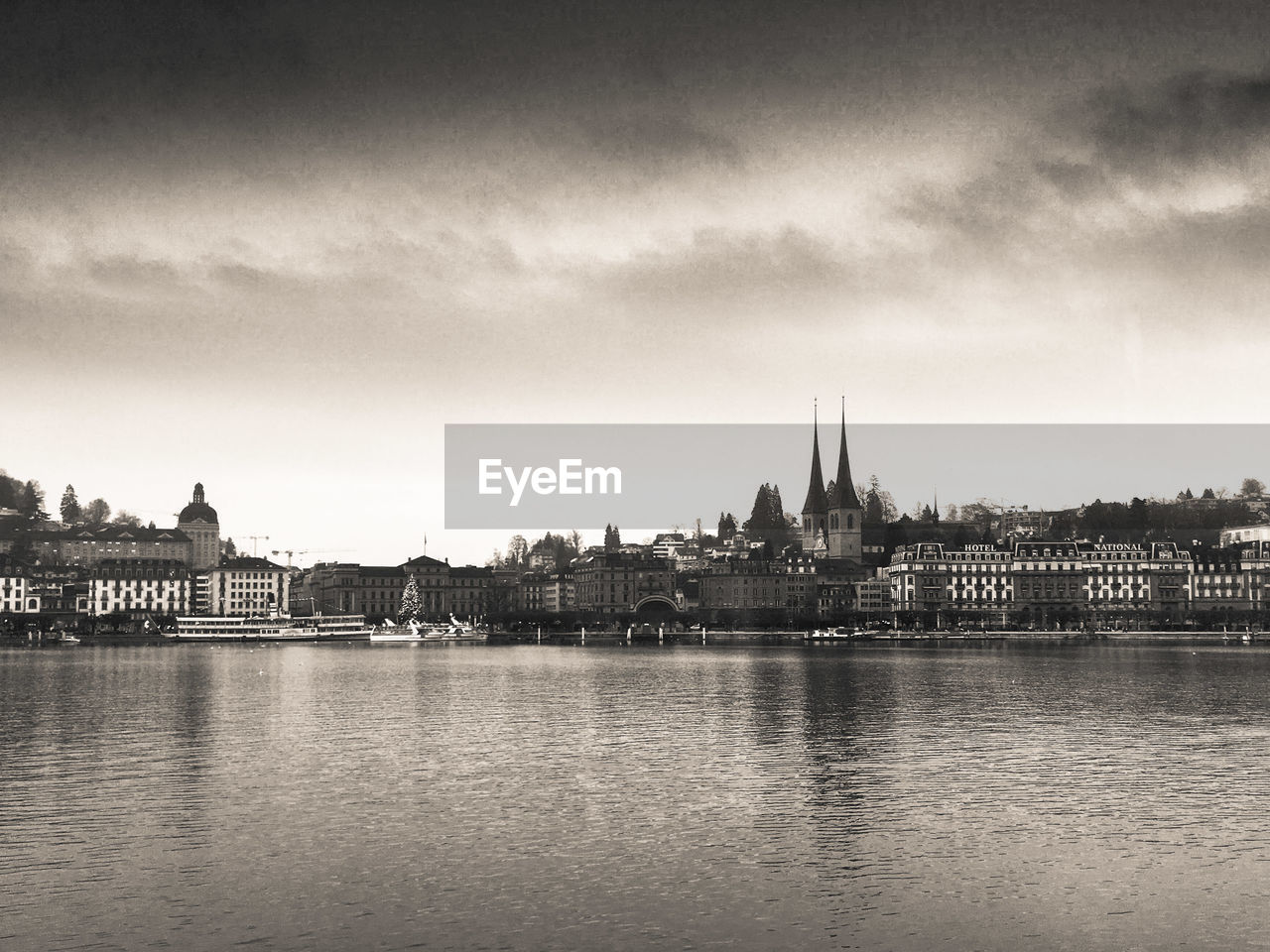 RIVER AMIDST BUILDINGS AGAINST SKY