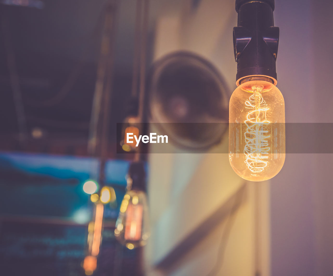 Low angle view of illuminated light bulbs hanging