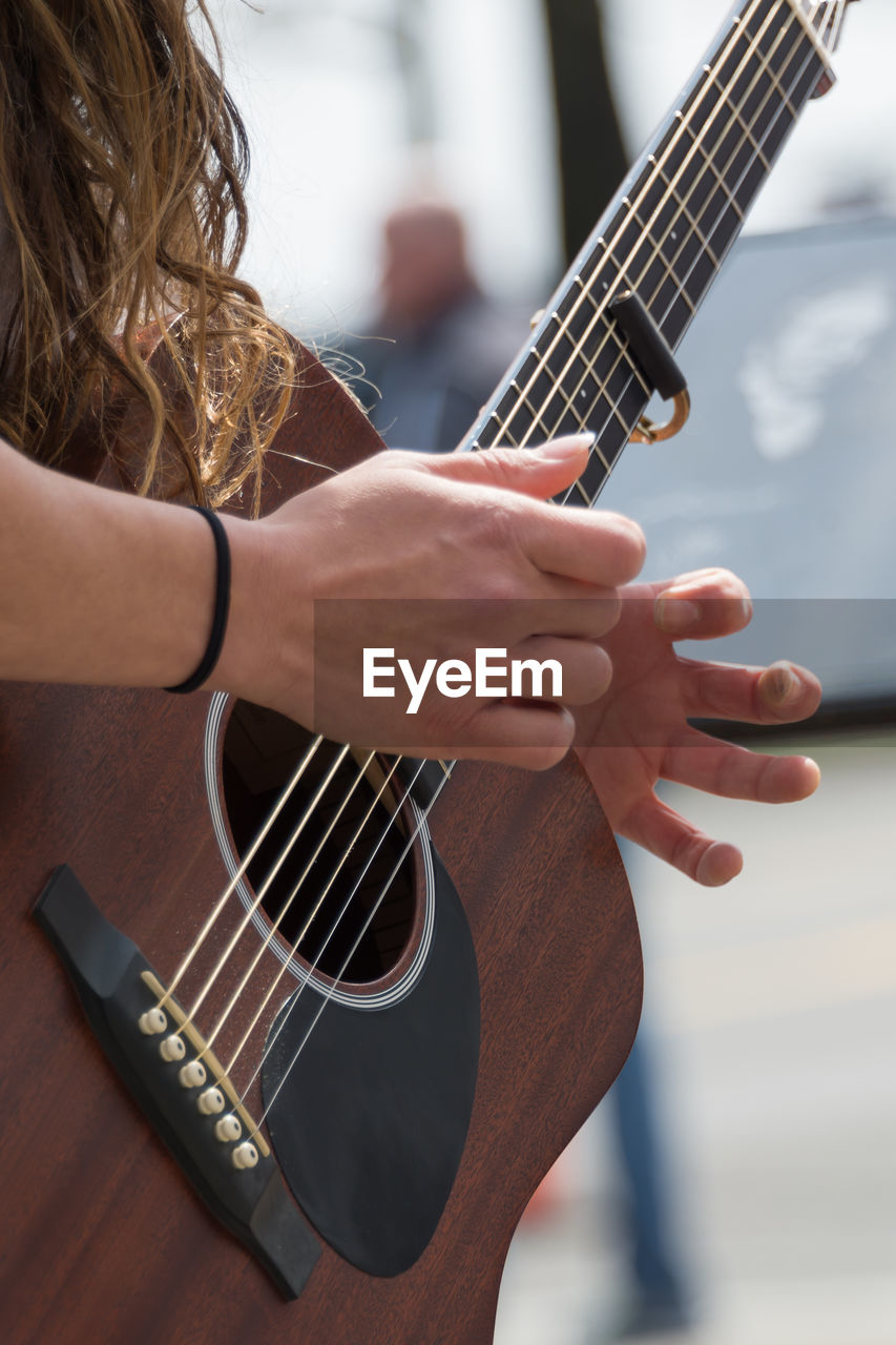 Close-up of woman playing guitar